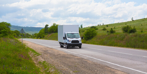 Wall Mural - Truck moves along a country road