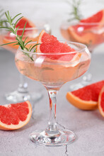 Goblet Of Sparkling Wine With A Slice Of Grapefruit And A Sprig Of Rosemary