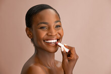African American Beauty Woman Applying Lipstick