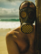 © Alex Sobrino - person in gas mask by the beach