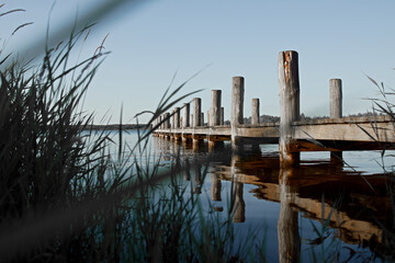 Poster - Wooden pier on the calm water during daylight