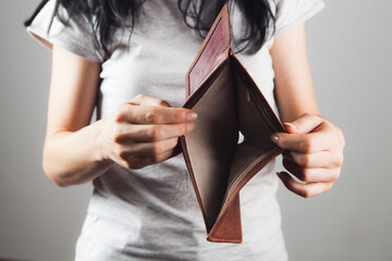 woman holding empty leather wallet