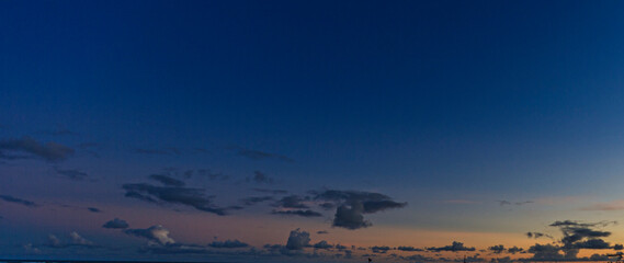 Wall Mural - Image of colorful evening sky with light clouds