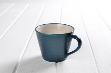 Tea in a blue cup on a white background