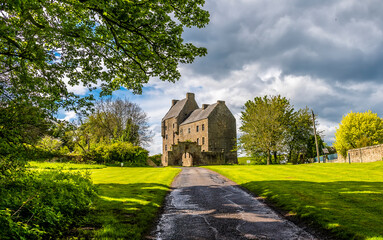 Wall Mural - A panorma view up a farm track towards Midhope castle, Scotland on a summers day