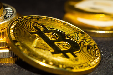 Wall Mural - Closeup shot of gold and silver bitcoins scattered on a surface illuminated with bright light