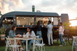 © Alessandro Biascioli - Happy multiracial people having fun eating in a street food truck market