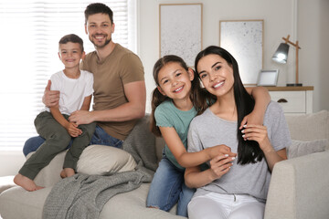 Canvas Print - Portrait of happy family in living room. Adoption concept