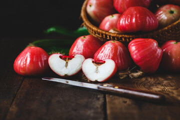 Sticker - Closeup shot of sliced red apples on the wooden table.