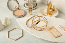 Stylish Golden Bijouterie On White Marble Table