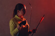 © primipil - Archer woman with modern block sport bow and arrow indoor.