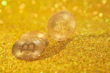 Three bitcoin coins. Cryptocurrency bitcoin is the coin of the future. Golden Bitcoin. Golden shiny background. High quality photo