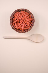 Poster - Vertical shot of macaroni with a spoon on a w background