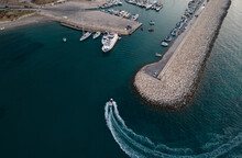 Aerial View Of Speedboat Entering The Harbor Yachts Moored At The Marina. Latsi Harbor Paphos Cyprus