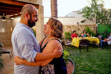 Mexican Couple In Their Forties Dancing At An Outdoor Garden Summer Celebration. 