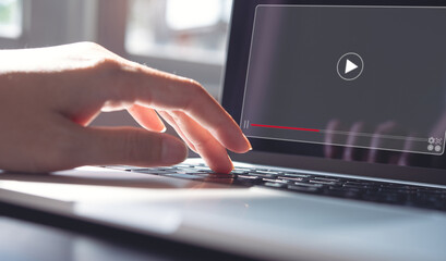 Woman working on laptop computer, watching video player, webinar, business online training, education on computer or e-learning concept, video tutorial, learn from home, telework concept