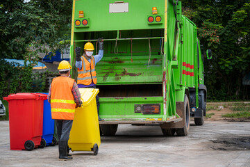 Wall Mural - Garbage collection service,Rubbish cleaner man in a uniform working together on emptying dustbins for trash removal with truck loading waste and trash bin,Recycling concept.