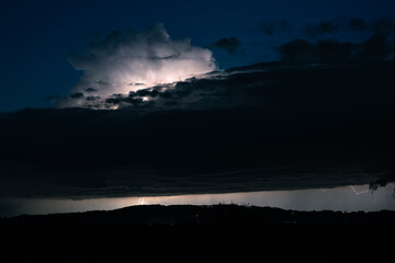 Sticker - Lightning is illuminating the top of a storm cloud