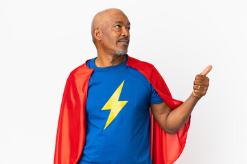 Super Hero senior man isolated on white background pointing to the side to present a product