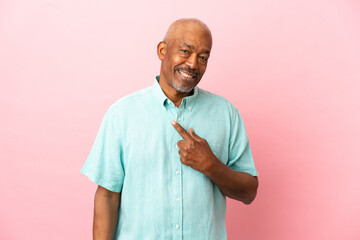 Wall Mural - Cuban senior isolated on pink background with surprise facial expression