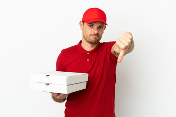 pizza delivery man with work uniform picking up pizza boxes over isolated  white wall showing thumb down with negative expression