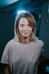 Wall Mural - Vertical shot of an attractive Caucasian woman with short, blond hair smiling in a cute way