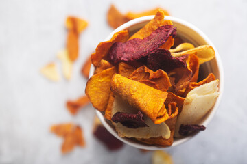 Vegetable organic chips in white glass top view