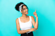 © luismolinero - Young latin woman isolated on blue background pointing up a great idea