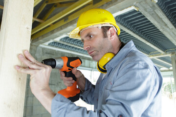 concentrated male builder with drill