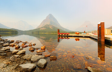 Wall Mural - Overview of beautiful sunrise of Boat Loading Dock at Swiftcurrent Lake. Swiftcurrent Lake is located in the Many Glacier region of Glacier National Park, in the U.S. state of Montana.