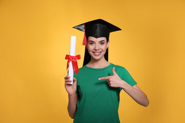 Poster - Happy student with graduation hat and diploma on yellow background