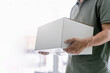 © NongAsimo - Delivery man use hand to lift the shopping box wearing protective mask for protection in delivery work