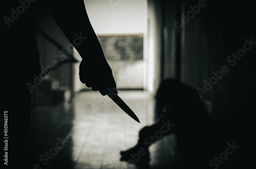 The murderer is holding a knife trying to hurt a weak woman. ignorant life problems Ready to use family violence concept of women\'s violence problem