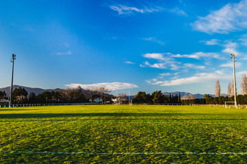 Football field in the morning sunlight (blue sky)