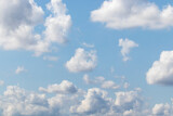 Fototapeta Niebo - White fluffy clouds on a blue sky.