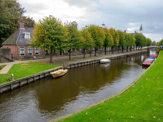 Wall Mural - Rows of houses and trees on Lindengracht quay along canal in Sloten, Sleat, Friesland, Netherlands