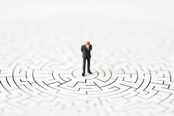 Wall Mural - Miniature Business people office man stand center of maze thinking business plan and how to solve problem using for Accounting Financial Banking business growth development and Commerce Strategy Plan