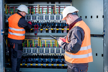 Wall Mural - checking the operating voltage levels of the solar panel switchgear compartment