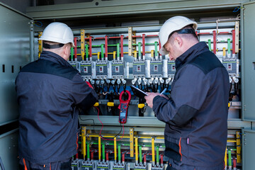 Wall Mural - checking the operating voltage levels of the solar panel switchgear compartment