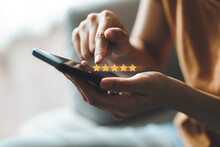 Close Up Of Woman Customer Giving A Five Star Rating On Smartphone. Review, Service Rating, Satisfaction, Customer Service Experience And Satisfaction Survey Concept..