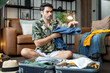 busy caucasian husband try to organize over travel cloth and stuff to suit in luggage travel concept,caucasian male wear casual cloth sit on floor arrange luggage to travel