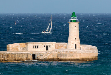 Grand harbour Valletta Malta, Yacht sailing in rough open sea.