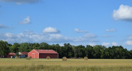 Barn and Hay Bales in a Field