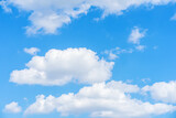 Fototapeta Na sufit - Bright blue sky with puffy white clouds, summer day sunlight
