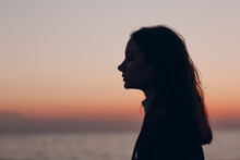 Young Beautiful Woman Profile Silhouette Portrait At Sunset