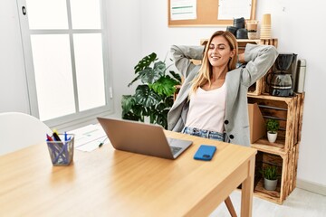 Wall Mural - Young caucasian businesswoman relaxed with hands on head at the office.