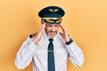 Poster - Handsome middle age man with grey hair wearing airplane pilot uniform with hand on head, headache because stress. suffering migraine.