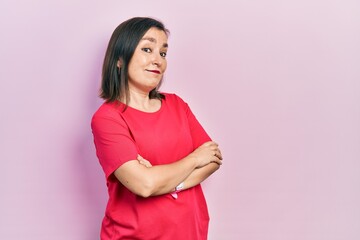 Sticker - Middle age hispanic woman wearing casual clothes looking to the side with arms crossed convinced and confident