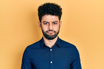 Canvas Print - Young arab man with beard wearing casual shirt depressed and worry for distress, crying angry and afraid. sad expression.