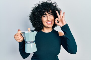 Sticker - Young middle east woman drinking italian coffee doing ok sign with fingers, smiling friendly gesturing excellent symbol